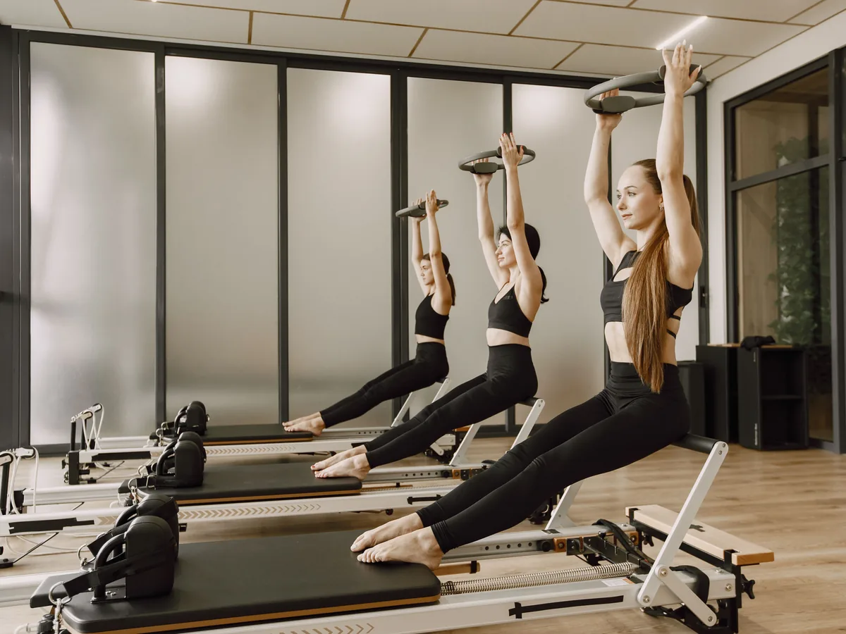 A full class mid-sequence, arms overhead