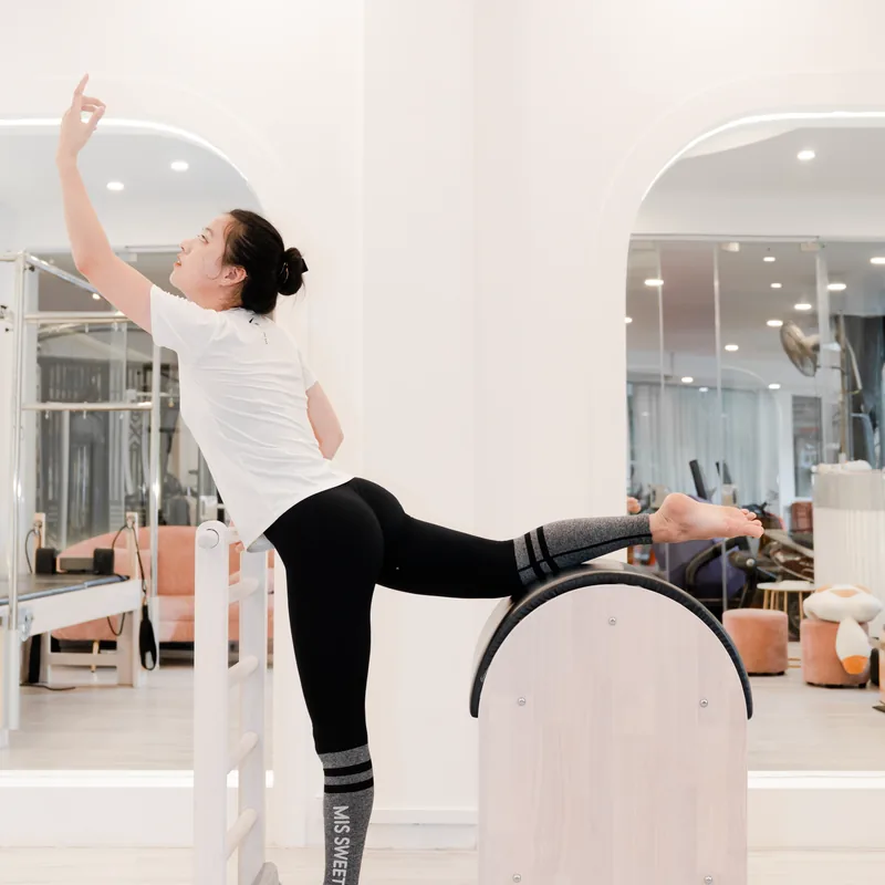 A coach stretching out on the equipment before class